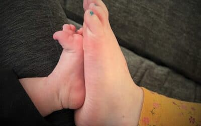 Toddler and baby feet together