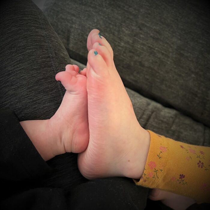 Toddler and baby feet together
