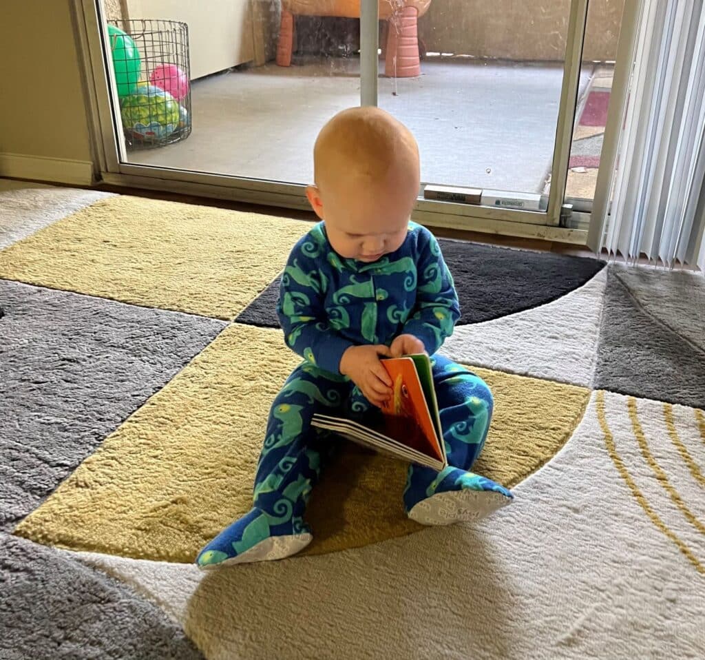 Baby Ben discovering a book.