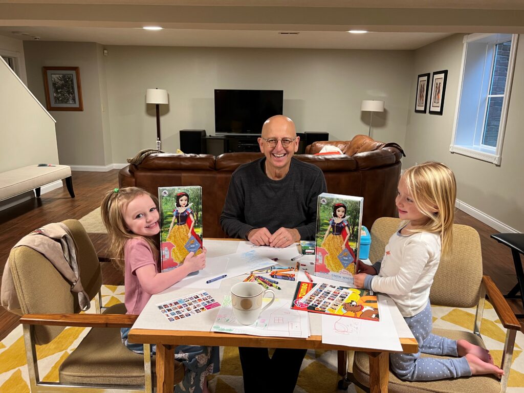 Two little girls with Snow White Dolls and Grandpa