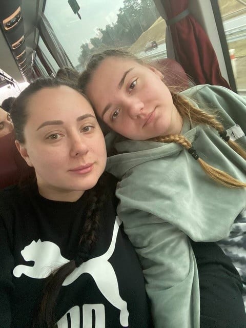 Two war refugees on a bus from Ukraine to Poland. 