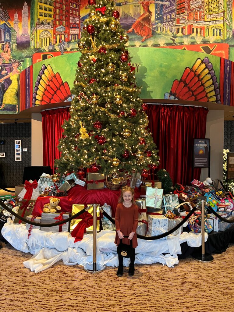 Adi by a Christmas Tree at the Theater.