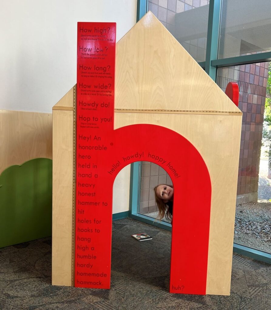 four-year-old girl playing in a "house" at the library.