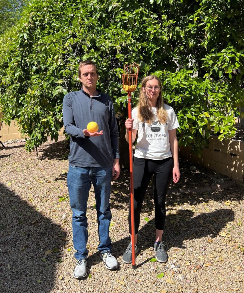 Adult sister and brother with grapefruit picker.