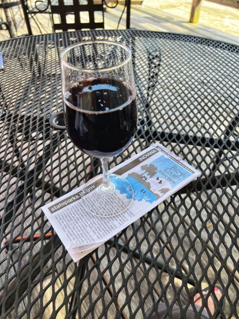 Glass of red wine atop a trail map.