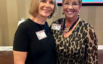 Two women, smiling at their 50th high school reunion